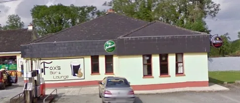 Fox's Bar & Lounge street-side view showing the pub signage and Carlsberg sign